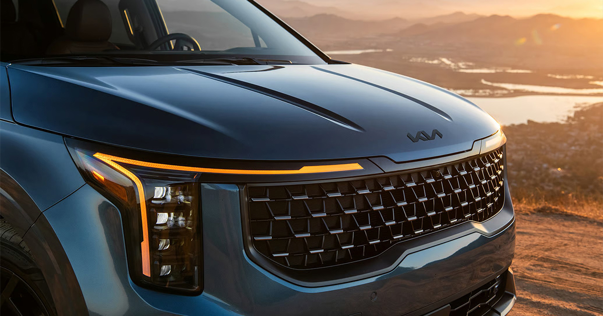 Close-up of Kia Carnival front headlight and grille design details