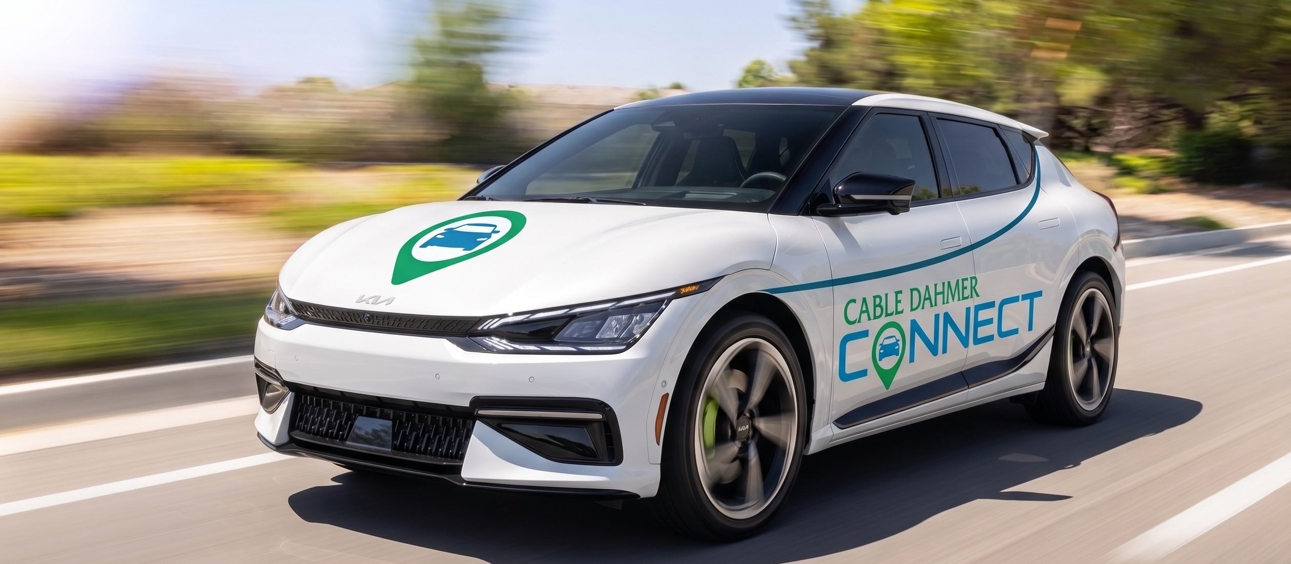 Cable Dahmer Connect branded Kia EV9 parked in a residential neighborhood for free pick-up and delivery service
