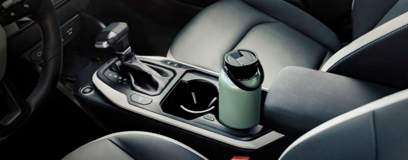 Center console in a 2025 Kia K4 with a water bottle